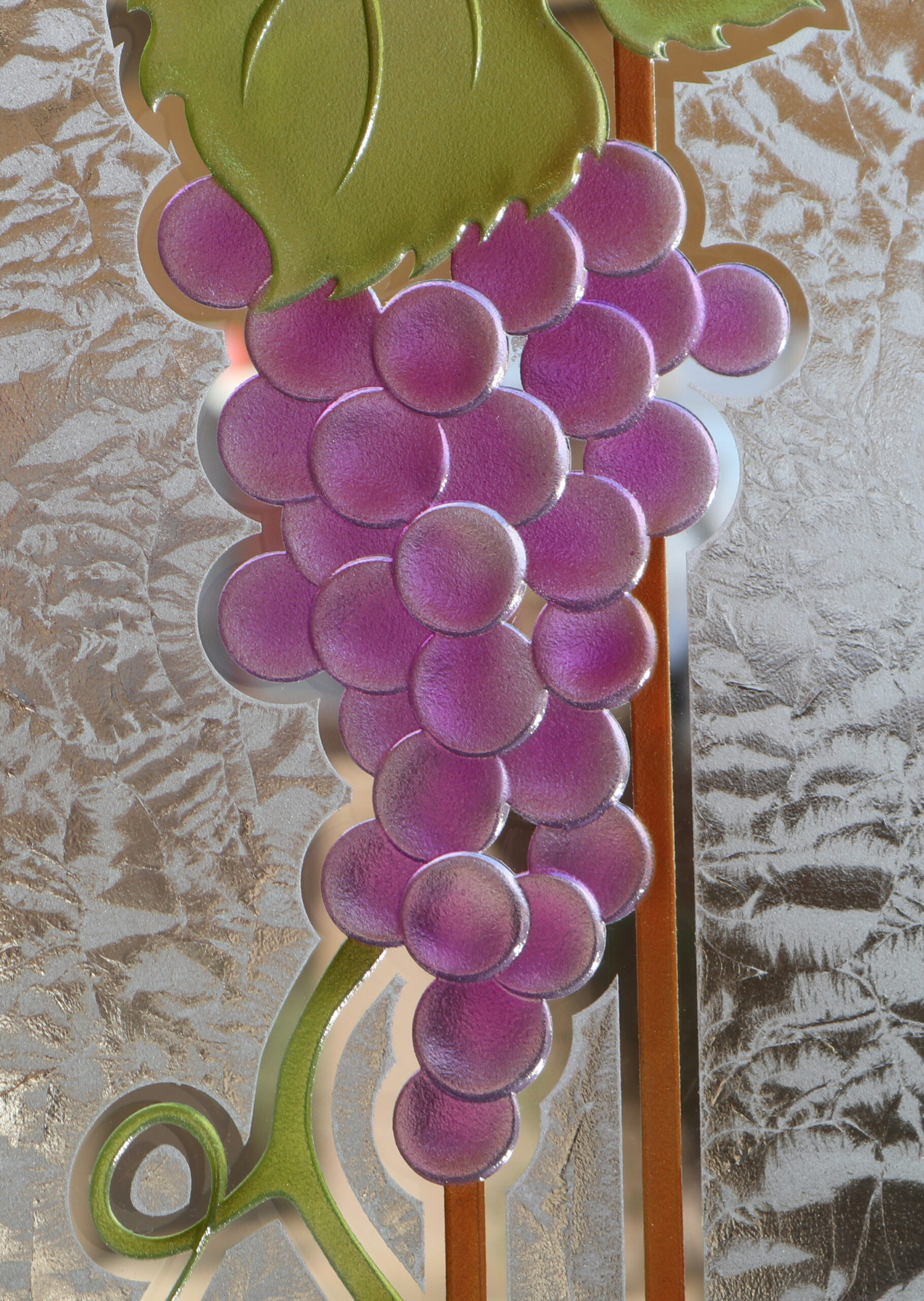 Close-up of 3D carved and painted grape cluster on gluechip frosted glass.