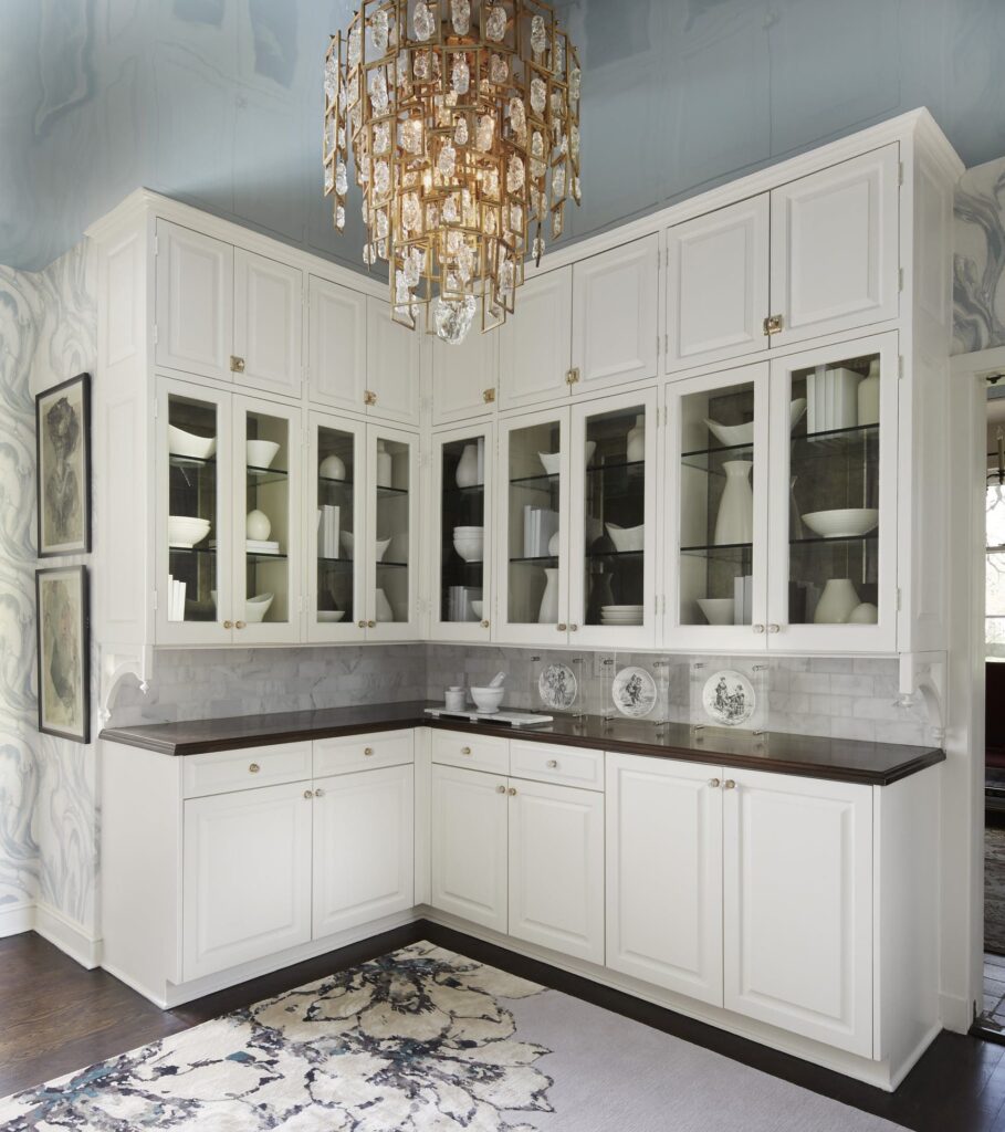 Lacquered blue ceiling, whimsically patterned wallpaper, and luxurious chandelier simple white butler’s pantry traditional design style 