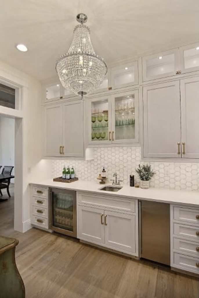 white butler pantry with glass chandelier traditional glam design style 