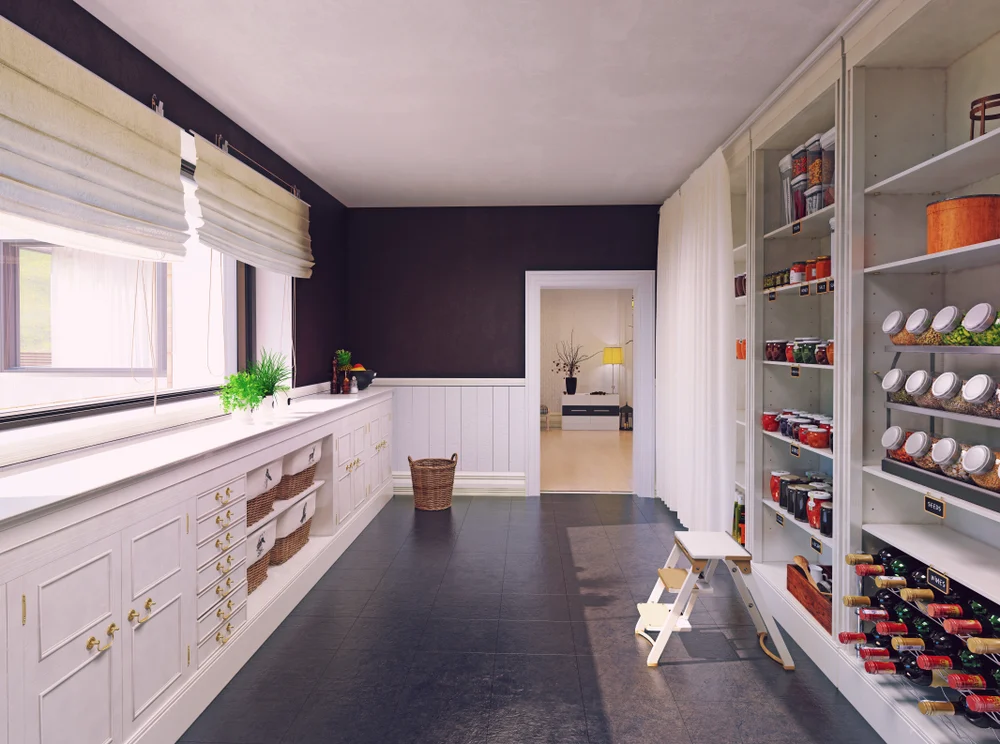 butlers pantry with large window white cabinetry