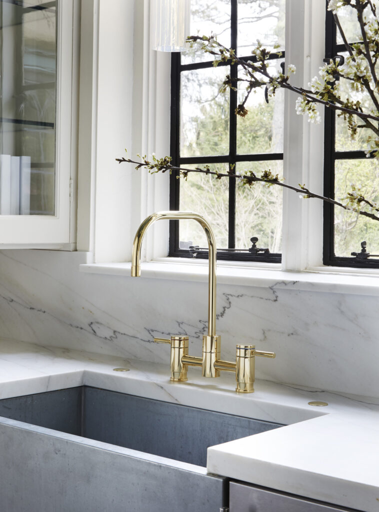 traditional butler’s pantry designed by designer Amy Kartheiser featuring gold faucet and sink