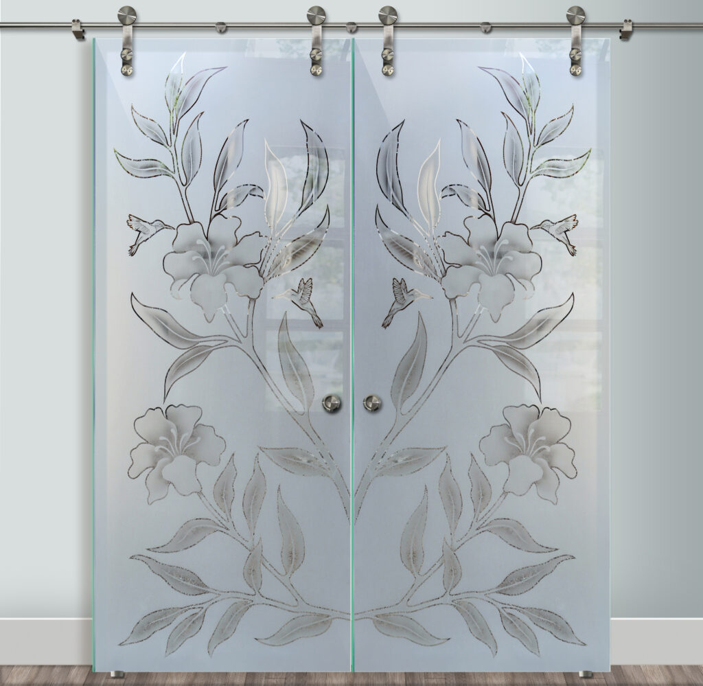 Decorative double barn doors with frosted etched glass showcasing mirrored hibiscus flowers and hummingbirds for an elegant statement entry.