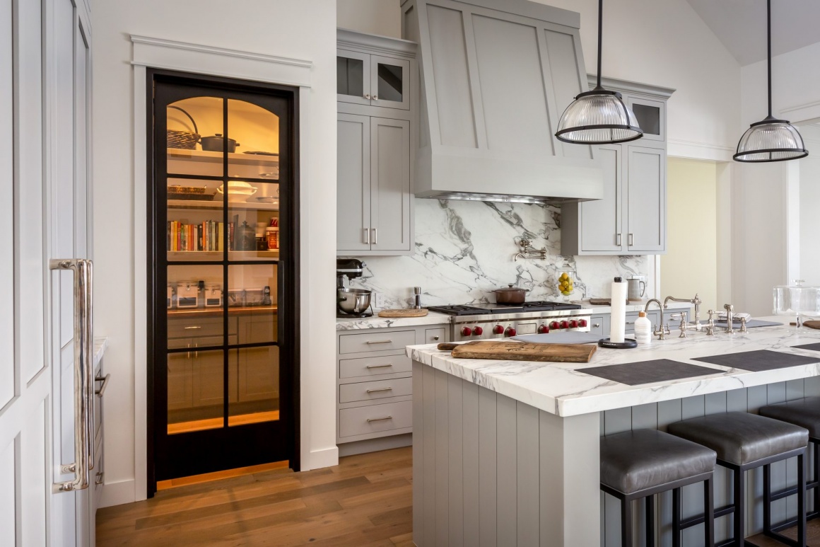 Clear glass pantry door highlighting organized kitchen storage
