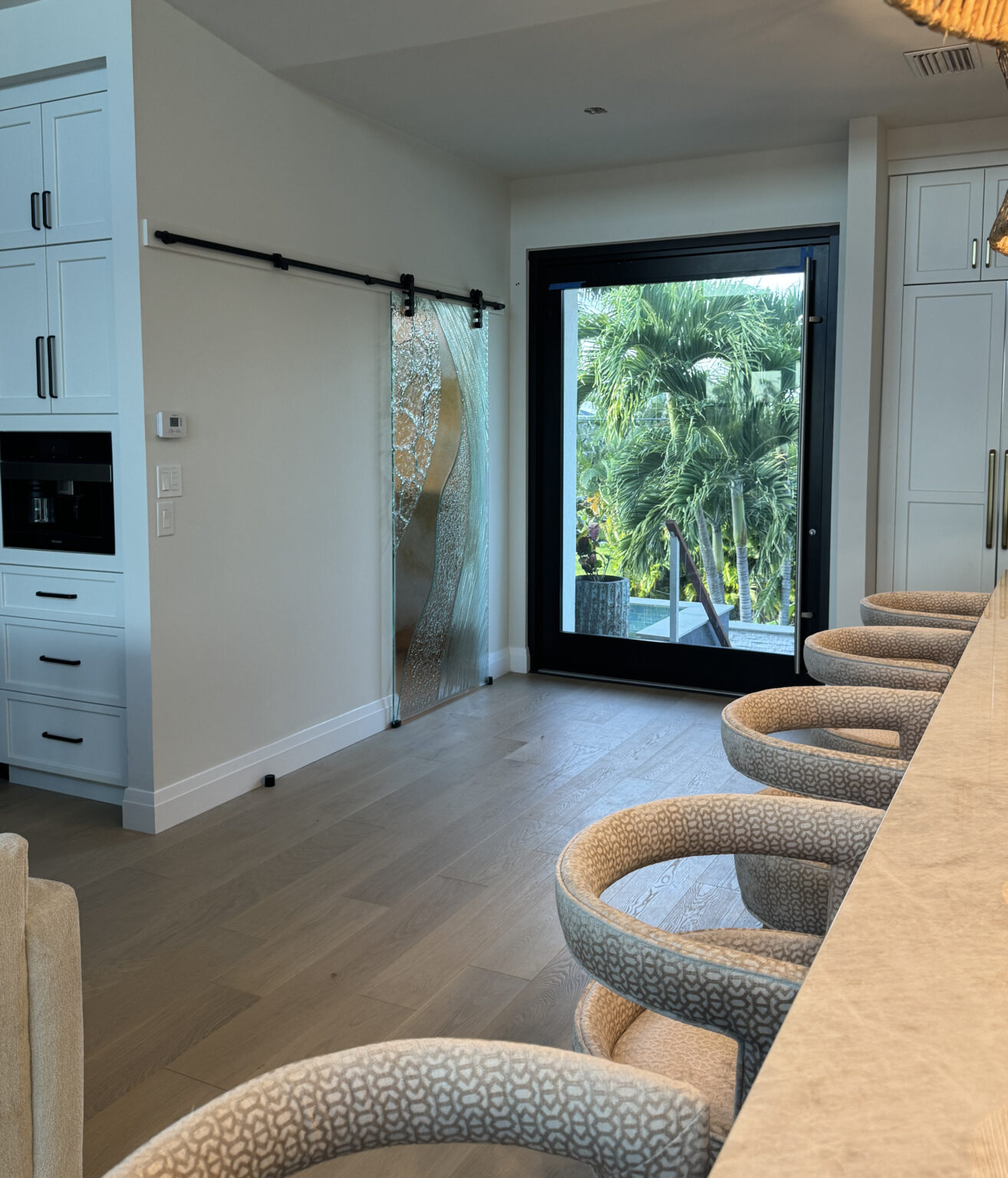 Frosted glass barn door with curved design in a home office