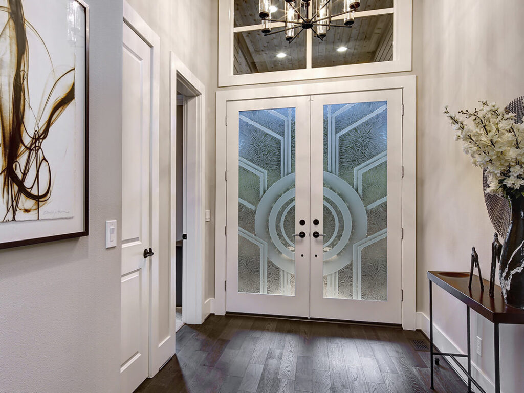Gluechip glass front doors with semi-private frosted patterns, showing how visibility softens at night while still allowing natural light &mdash; custom glass front doors handcrafted in the USA.