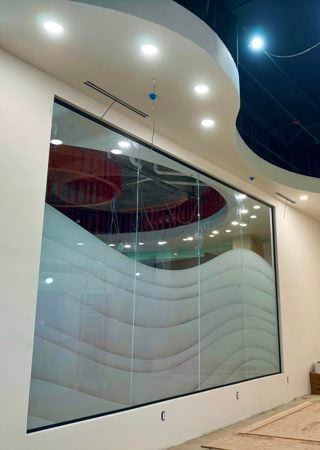 Partition showcasing a Frosted Glass Abstract Design with Sandblast Etched Glass Art by Sans Soucie Dreamy Waves Design