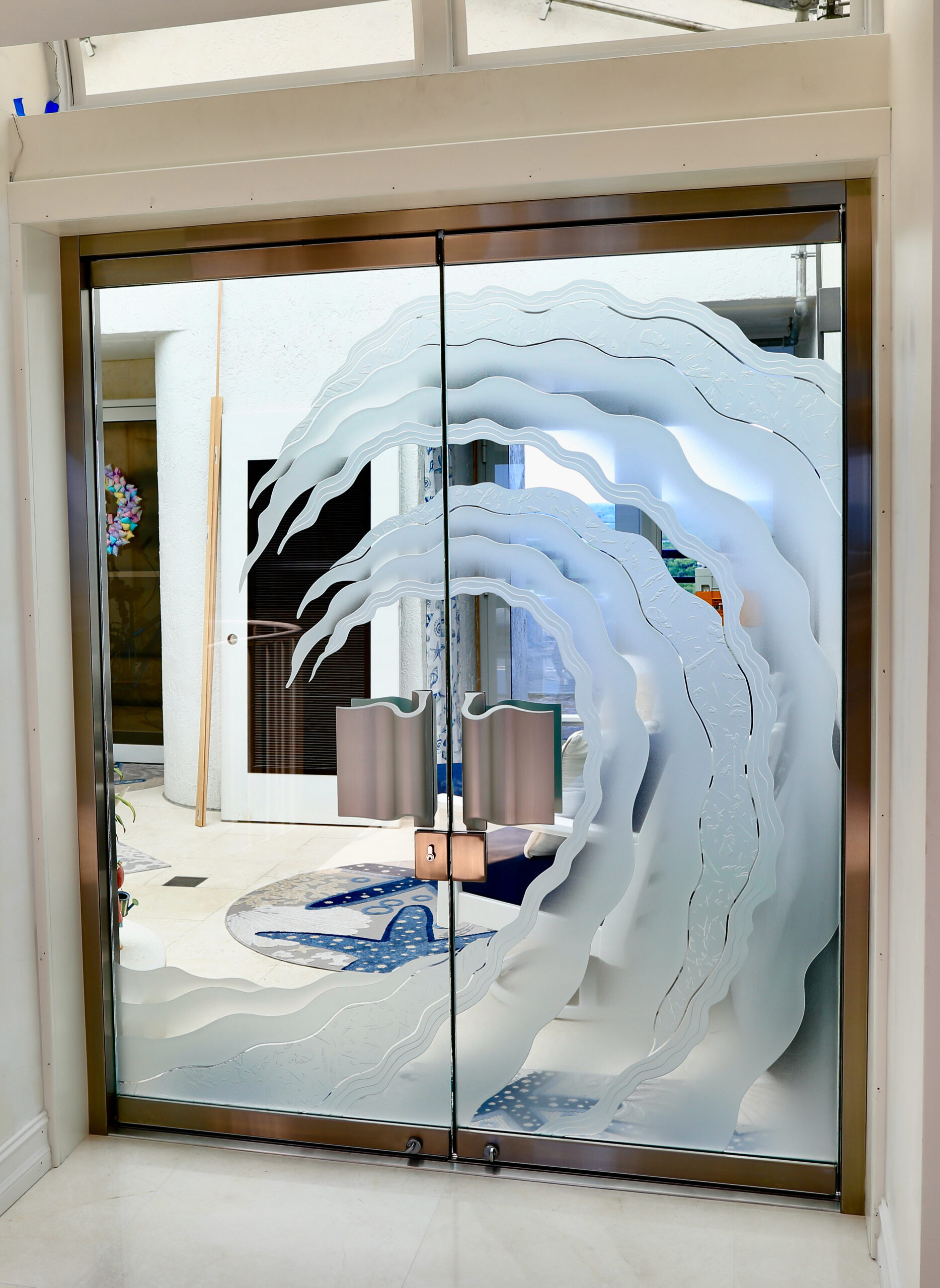Frameless glass doors with decorative glass coastal design