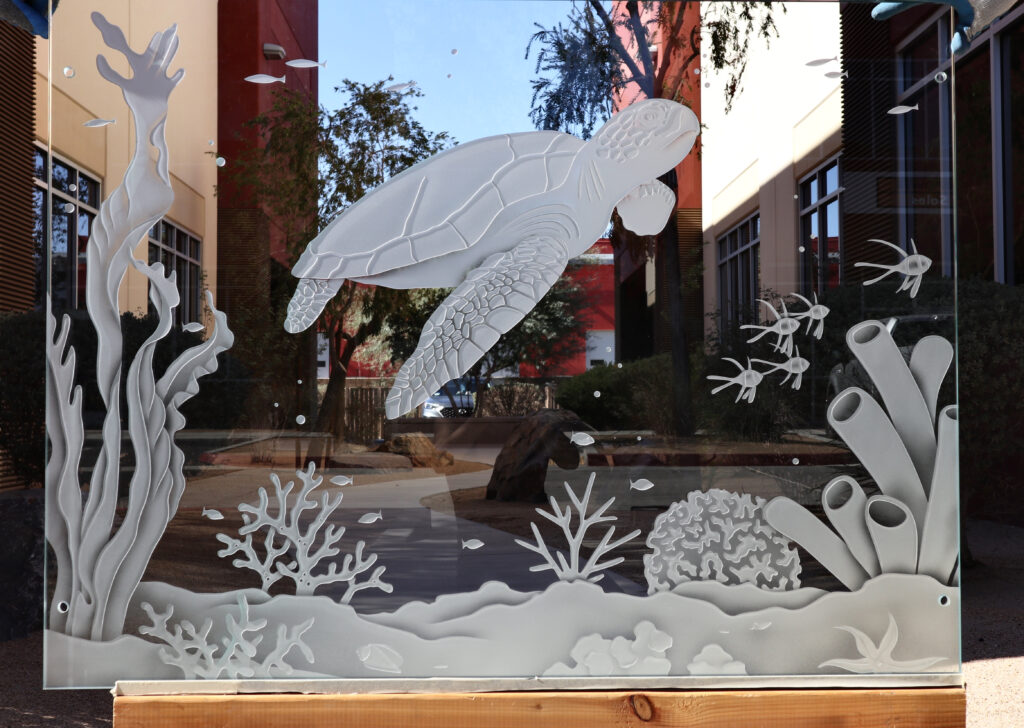 Glass partition panel with carved sea turtle and coral reef design in etched art glass
