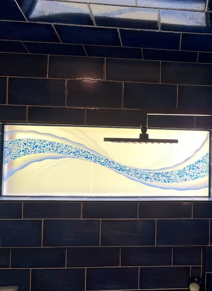 Decorative frosted glass window with blue wave design adding color and visual interest to space