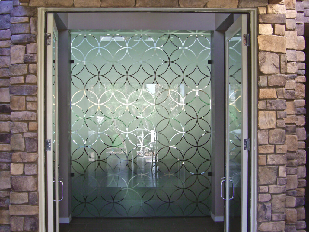 Modern frosted glass divider with intersecting circular design for contemporary space