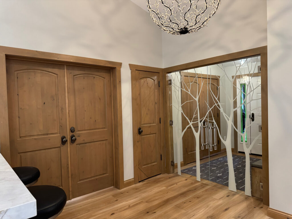 Frameless glass interior doors with sleek trees design