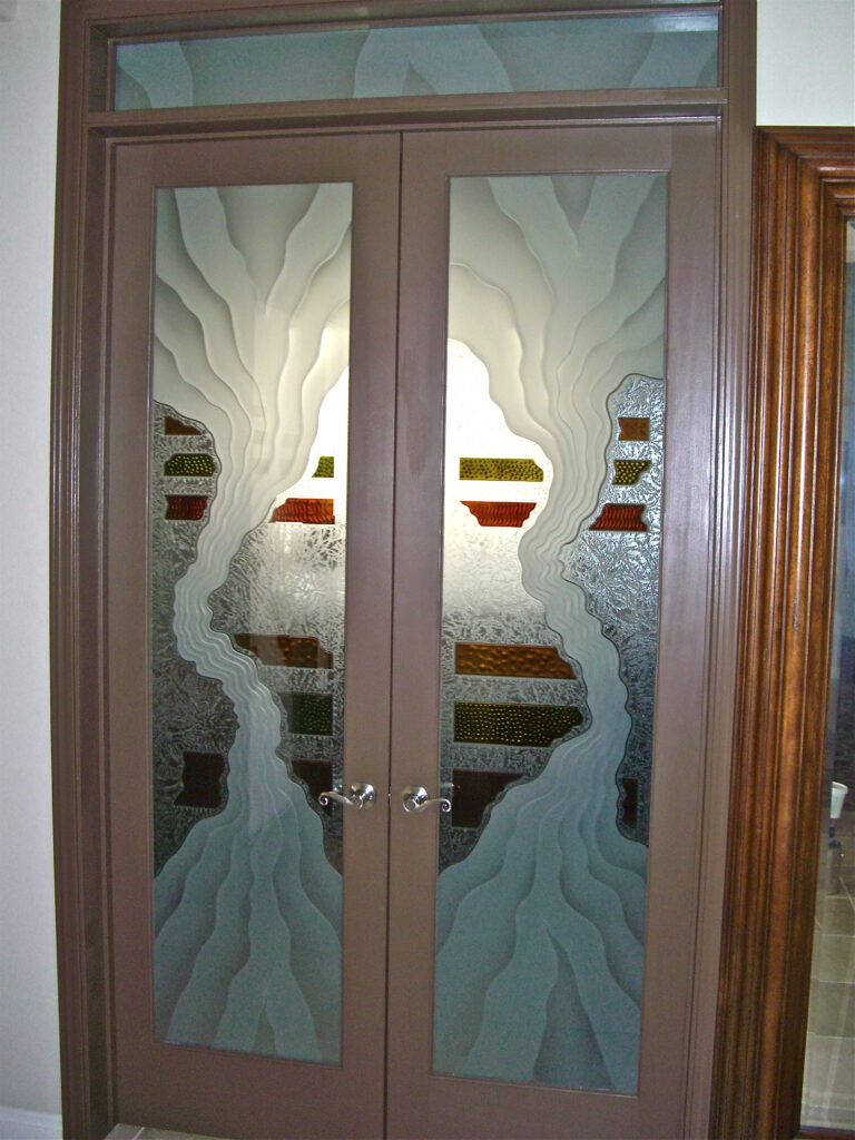 Double front doors with frosted glass featuring abstract carved and painted Triptic design