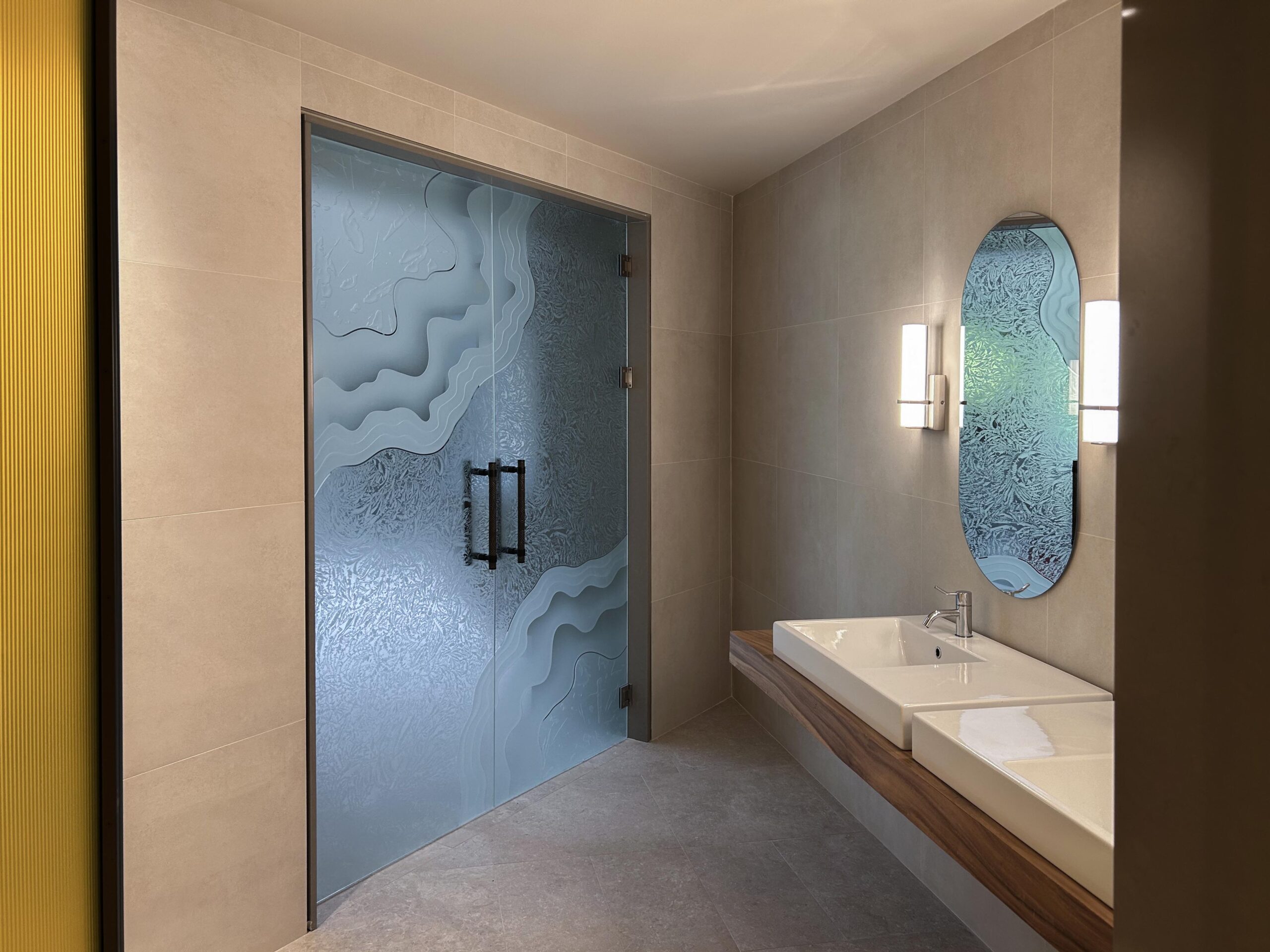 Sculpted frosted glass interior doors with layered carved design used as a modern bathroom entry door