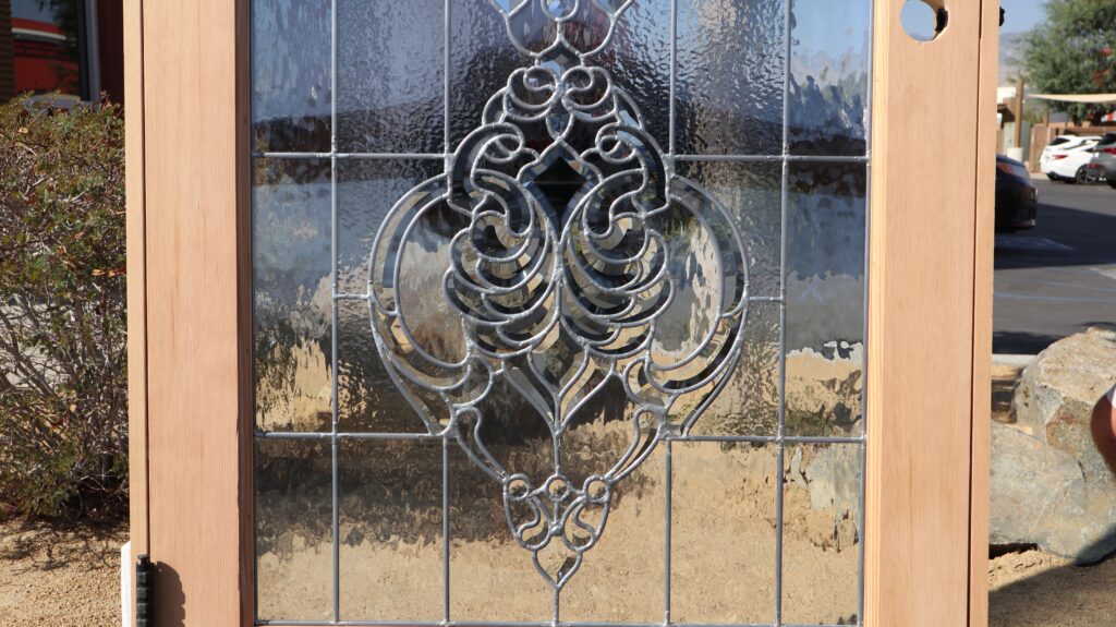 Detailed look at ornate beveled glass design, a striking option for a black front door with sidelights that enhances curb appeal while maintaining privacy.