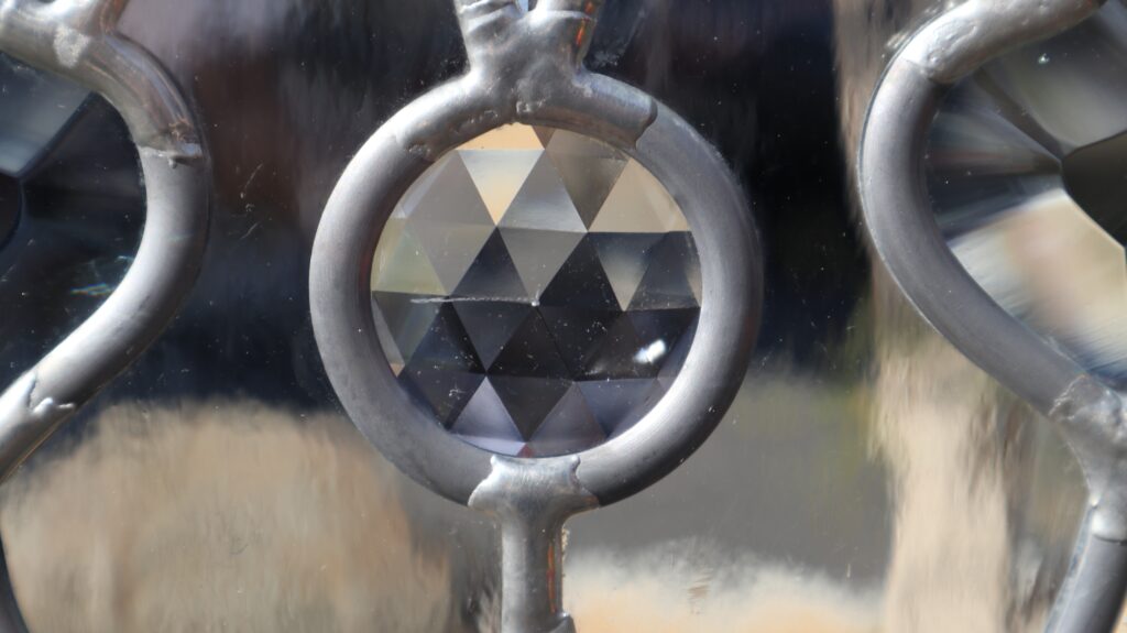 Close-up of beveled glass with geometric detail, ideal for a black front door with glass panels that adds elegance, depth, and visual interest.