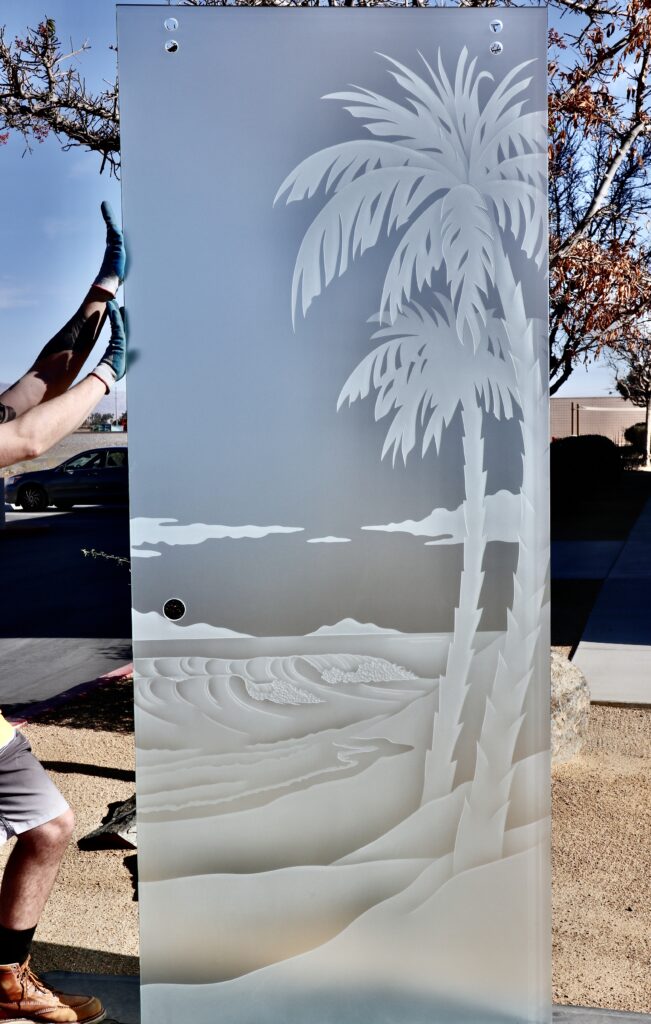 Solid frosted privacy glass panel with carved palm tree and layered sand dunes design