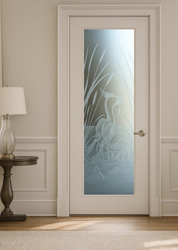 Frosted interior door featuring an etched crane and cattails design in frosted glass for privacy with artistic detail