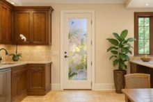 Traditional kitchen interior featuring a decorative glass for pantry doors with a vibrant frosted floral design and painted hummingbirds.
