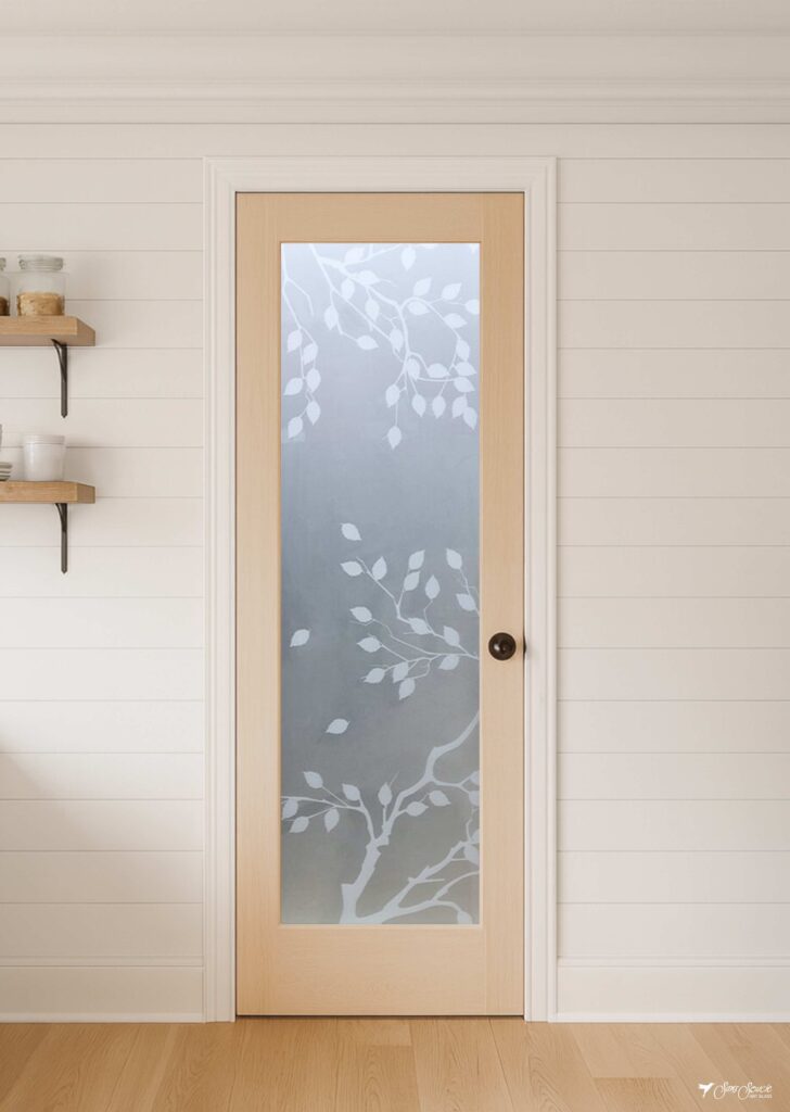Farmhouse pantry door featuring the Cherry Tree frosted glass insert, framed in natural wood and showcasing artistic etched and/or painted details.