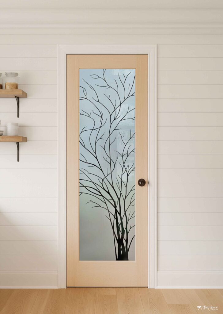 Farmhouse pantry door featuring the Wispy Tree frosted glass insert, framed in natural wood and showcasing artistic etched and/or painted details.
