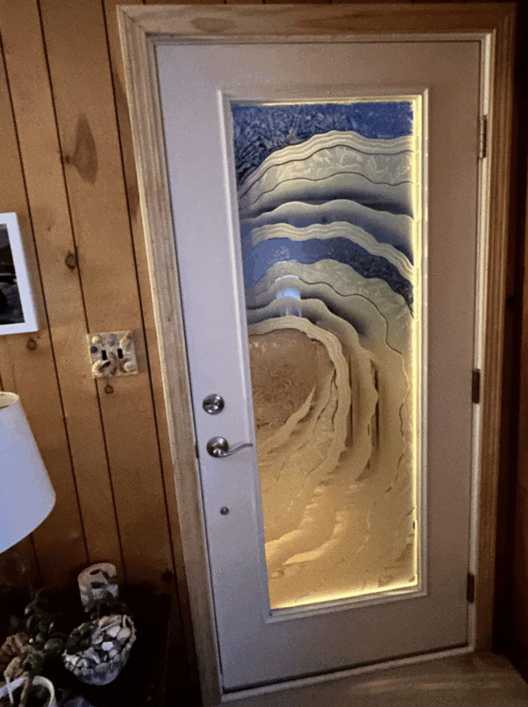 View from inside a home at night through a frosted glass front door with a semi-private design. The glass blocks outside visibility.