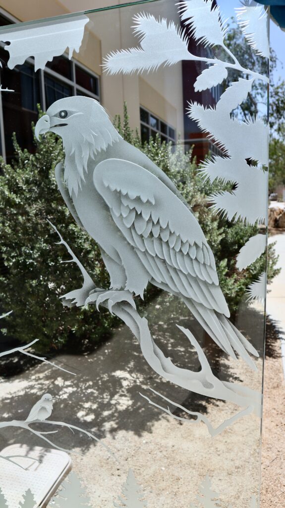 Detailed eagle carving in a Woodland Scene decorative glass partition panel with forest landscape elements