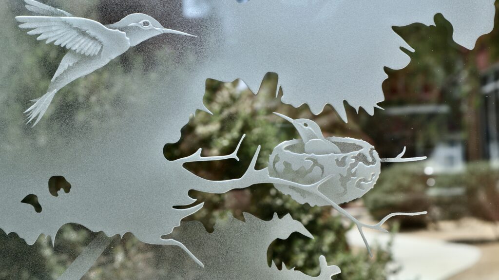 Woodland Scene glass panel featuring a bird nest carved into tree branches and frosted foliage