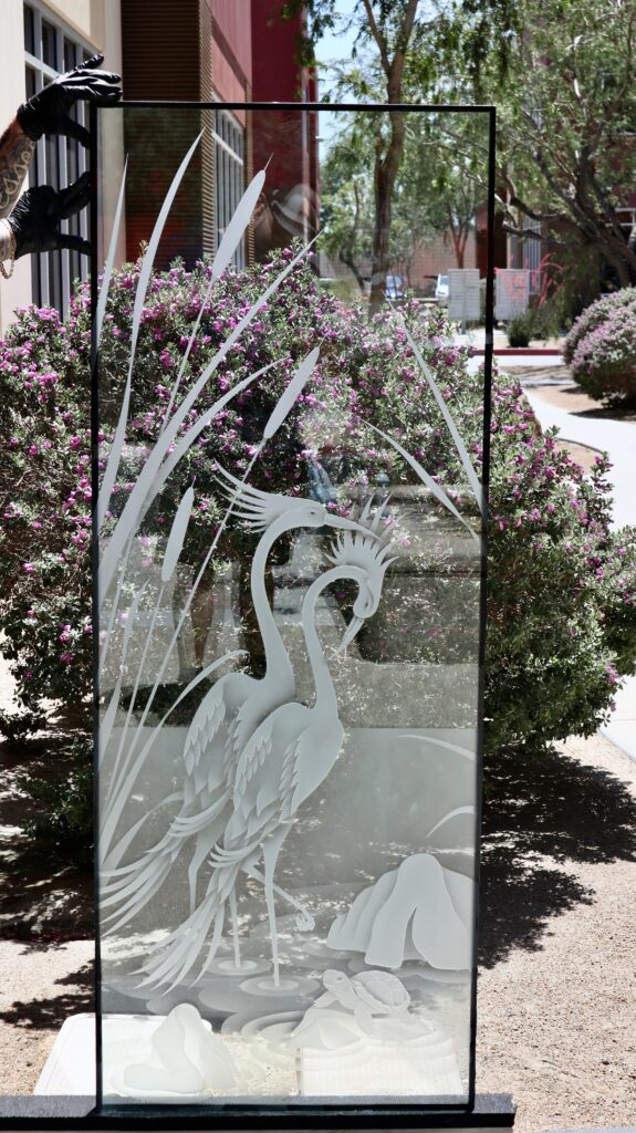 Decorative glass entrance design with cranes, cattails, and turtle artwork, showcasing custom glass door designs for nature-inspired homes.