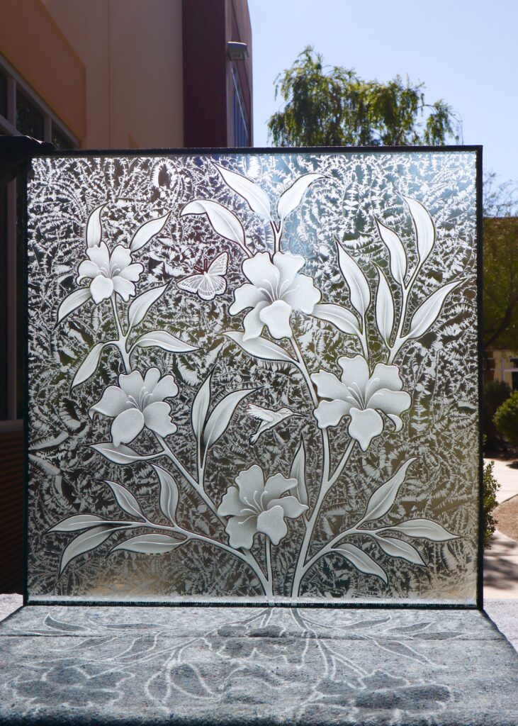 Decorative glass partition panel with hibiscus flowers, hummingbirds, and textured frosted glass background.