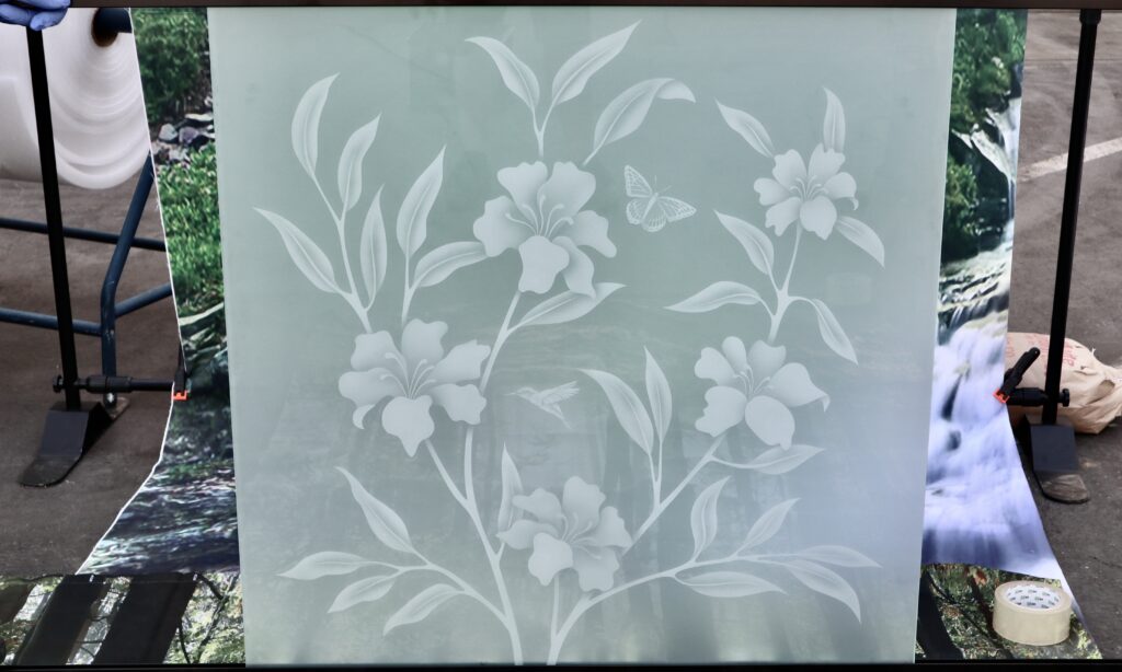 Hibiscus glass partition panel with frosted flowers, leafy vines, and butterflies in a soft 2D privacy glass design.
