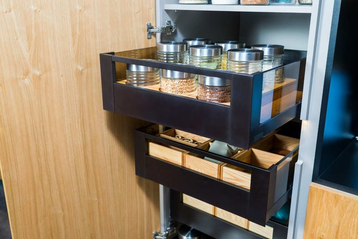 Pull-out sliding pantry shelves showcasing efficient small kitchen pantry ideas.