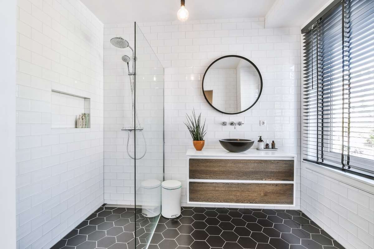 White minimalist interior showing a glass shower panel.