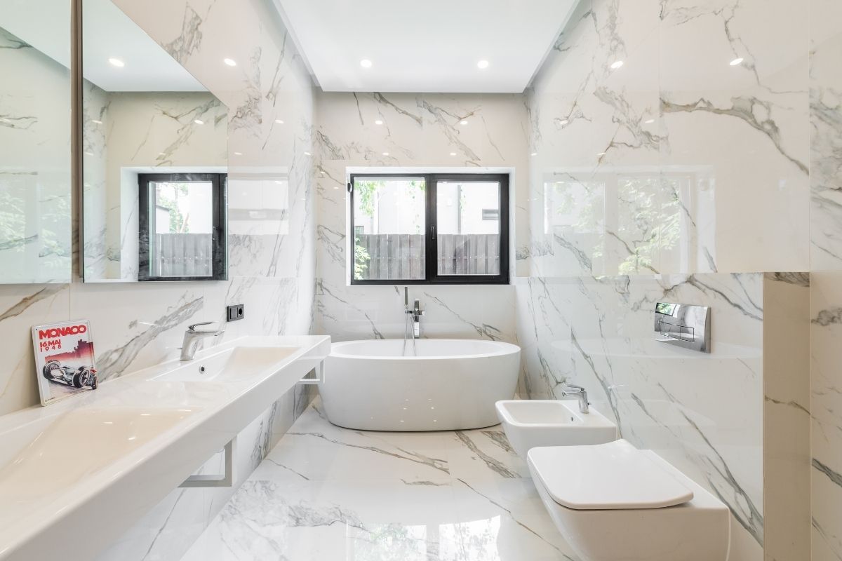 White minimalist wet room interior showing walk-in design without partitions in contrast to glass shower panels