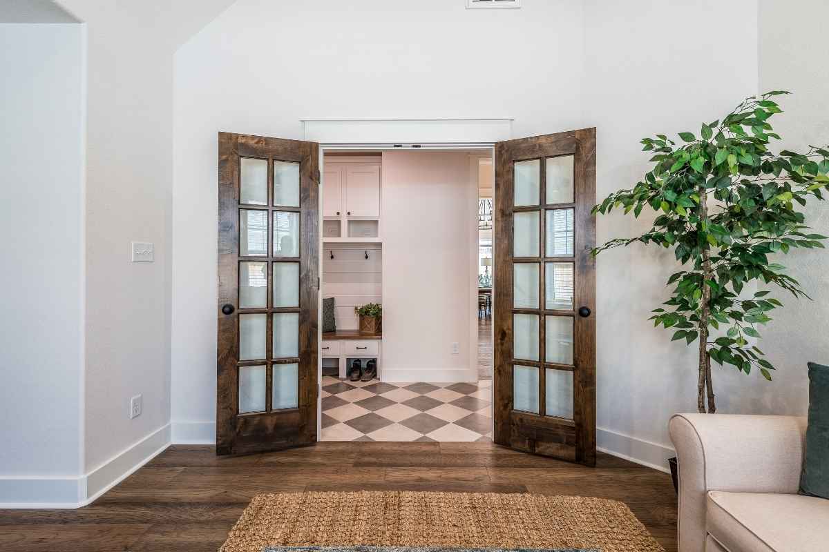 Living room design showing French doors vs double barn door glass for style comparison.