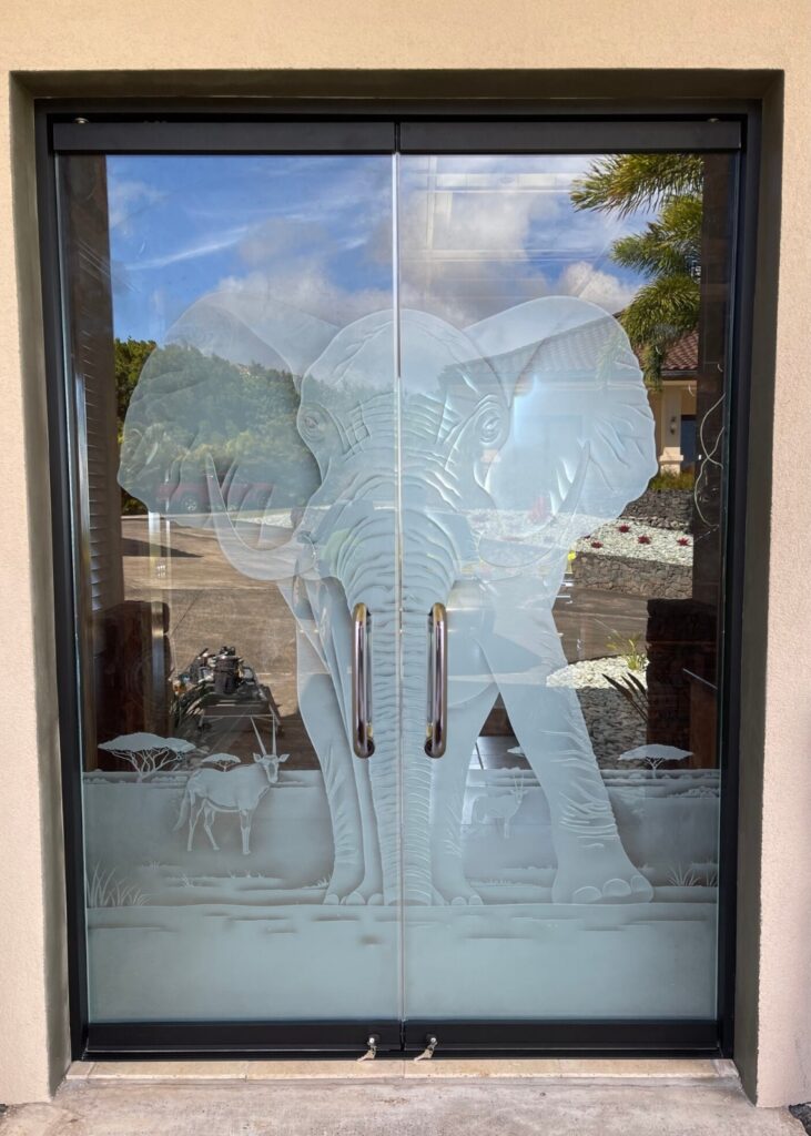 Full glass exterior door installed in a modern commercial storefront.