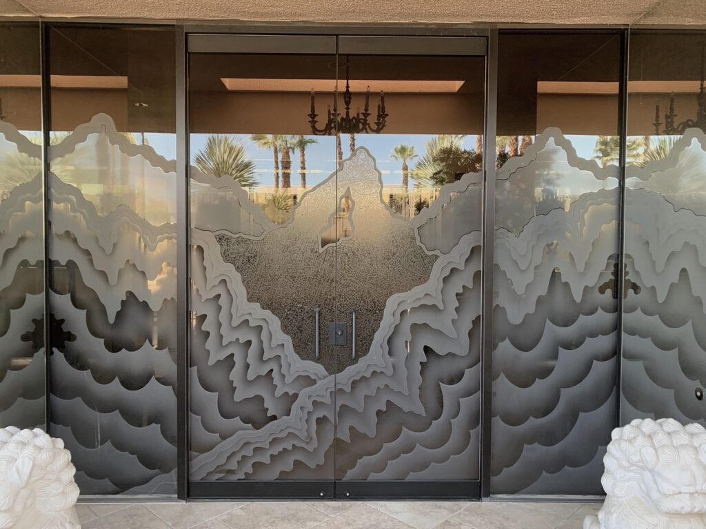 Stunning carved all glass double exterior doors with layered abstract mountain design