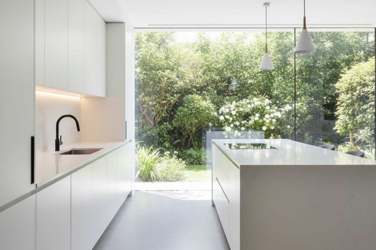 Contemporary kitchen with wide fixed window showcasing outdoor garden, fixed glass window idea for bright and open design