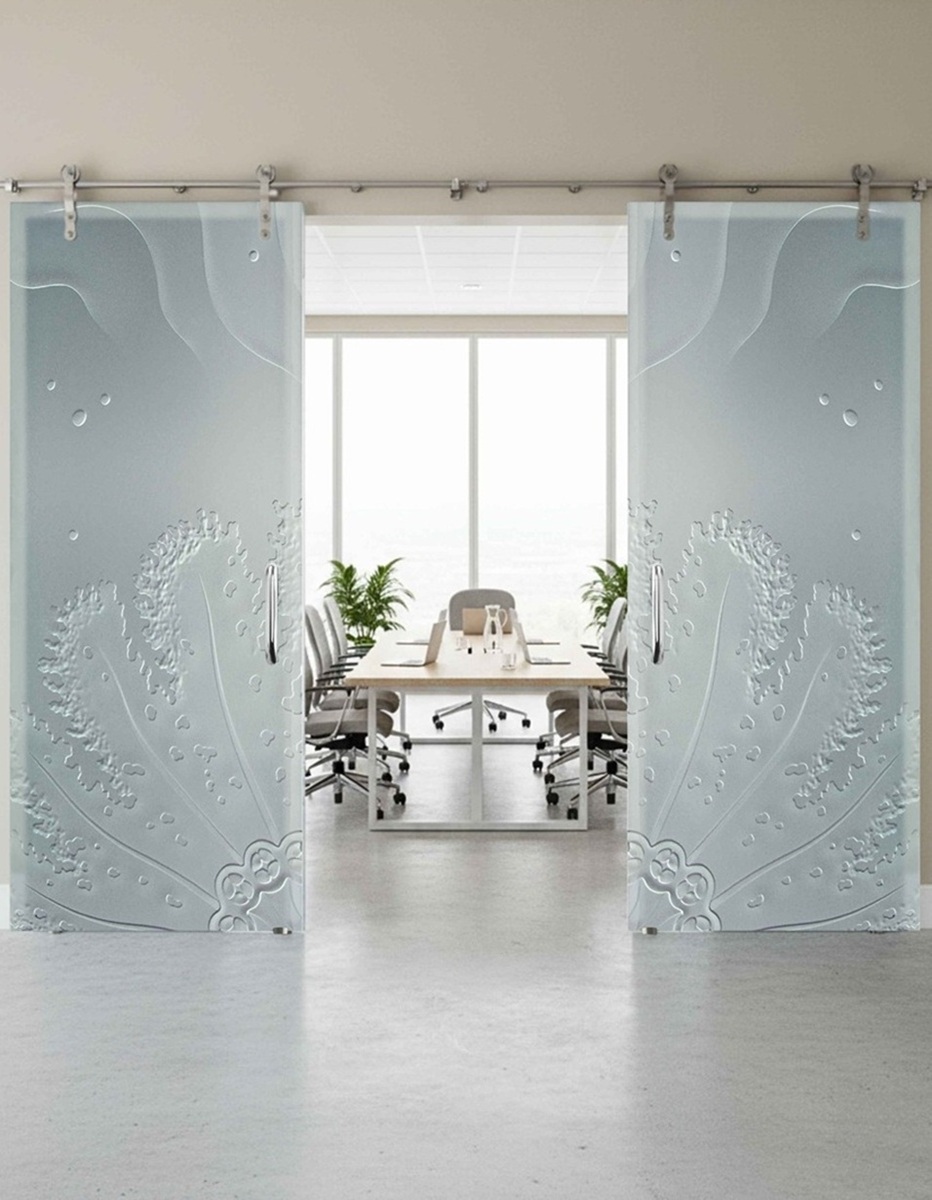 Glass barn doors for an office, featuring frosted patterns and ripple design that enhance a bright, modern office setting.