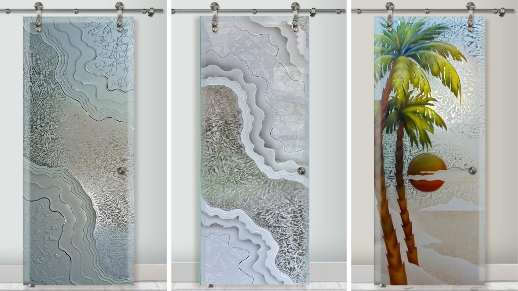 Best glass barn doors by Sans Soucie Art Glass, an expert art glass studio. Examples include carved waves, textured glass, and a hand-painted palm tree scene.