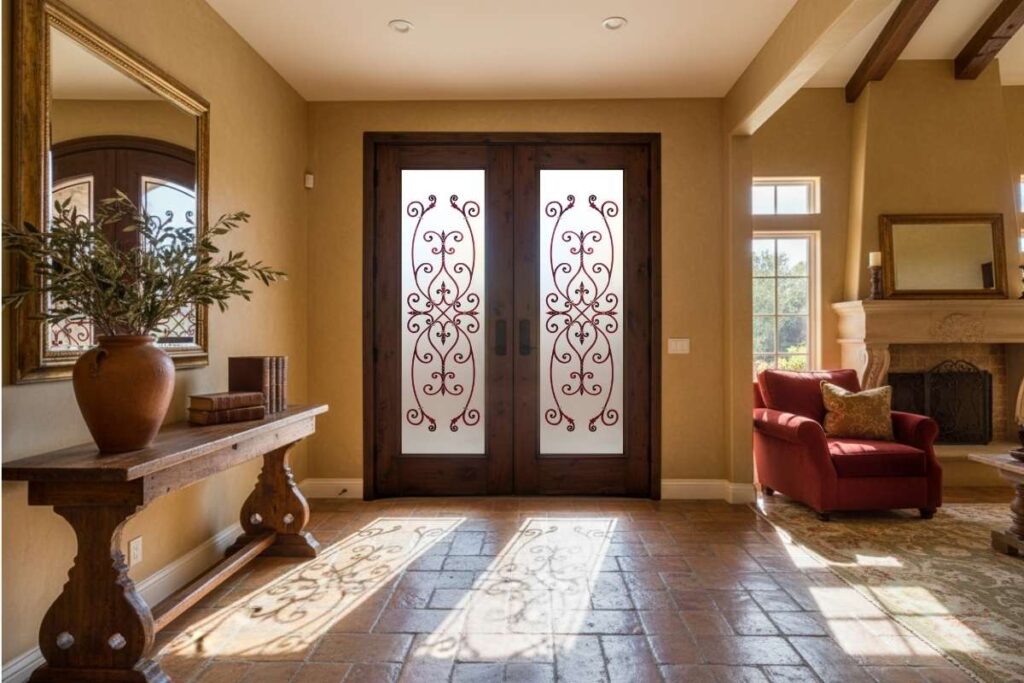 Old-World style interior entry with dark wood double doors featuring ornate frosted glass panels