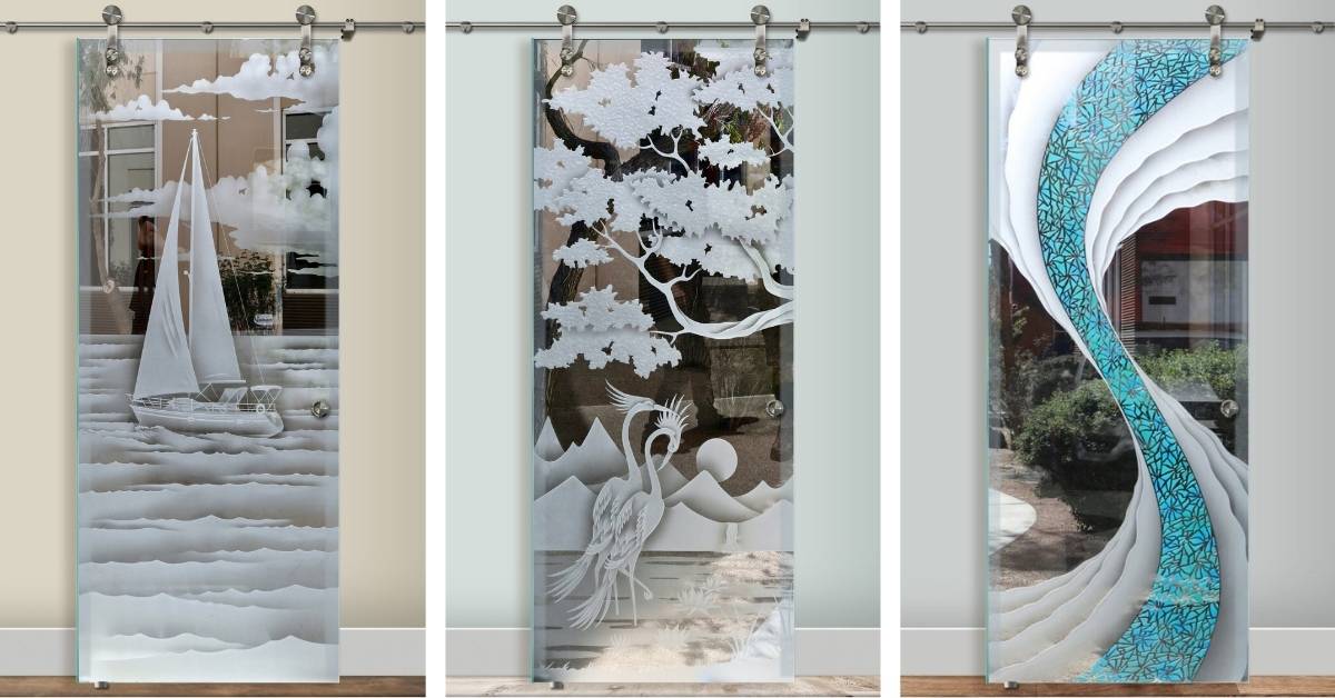 Professionally designed custom glass barn doors featuring etched sailboat, tree with cranes, and colored wave patterns, showcasing expertly crafted decorative artistry for interior spaces.