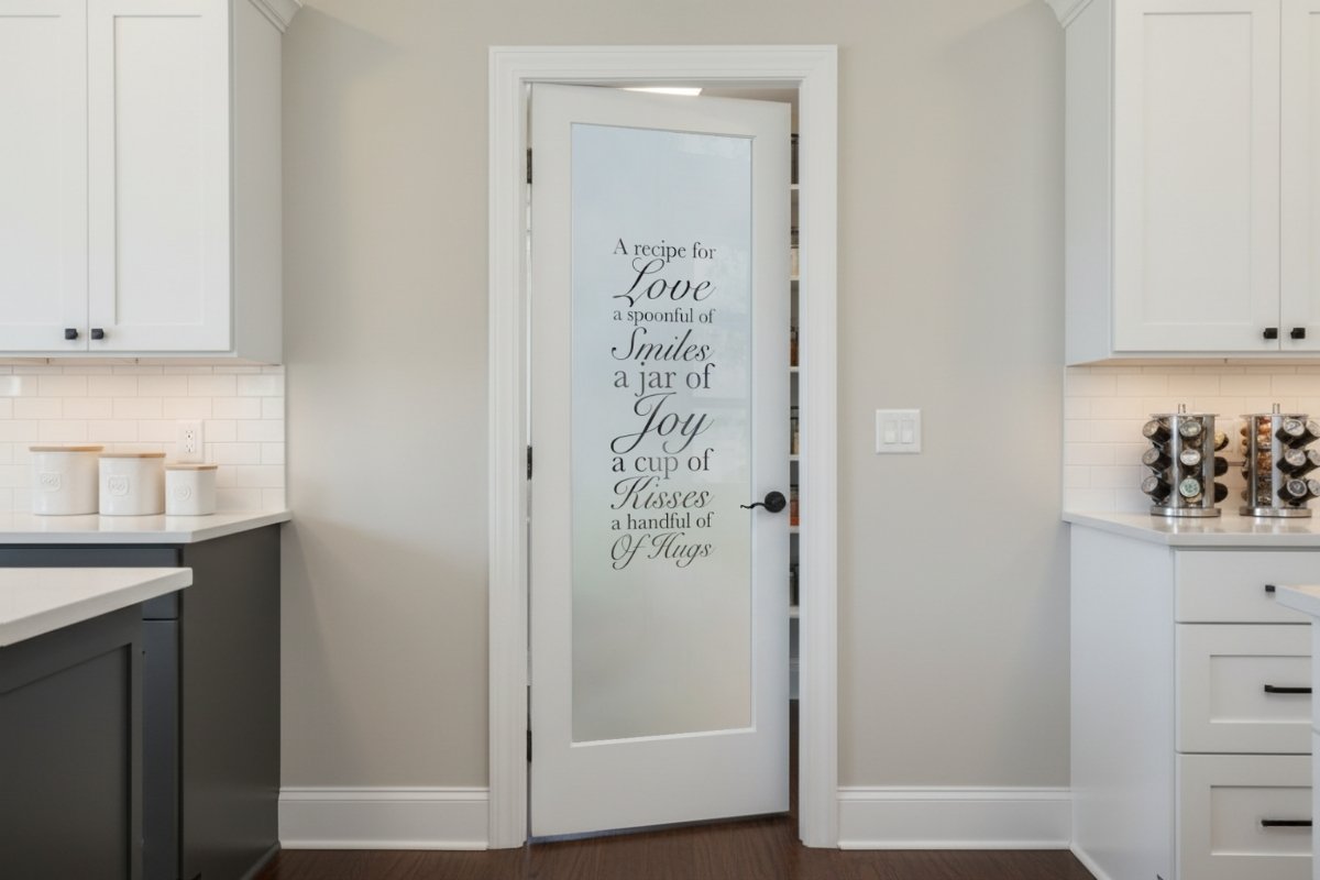 Contemporary kitchen with a frosted glass pantry door etched with &ldquo;Recipe for Love&rdquo; text, swinging inward into the pantry for a smooth kitchen layout.