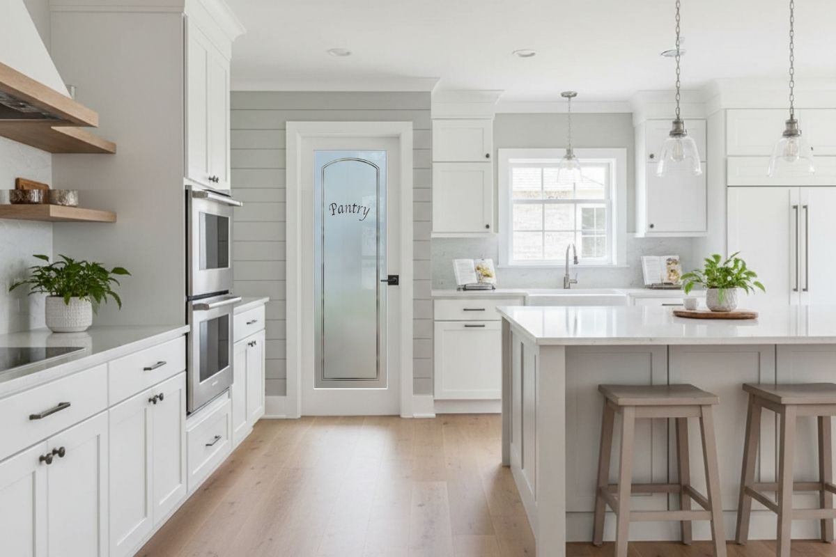 Bright modern farmhouse kitchen with a classic arched frosted glass pantry door design etched with &ldquo;Pantry,&rdquo; professionally crafted by Sans Soucie Art Glass.