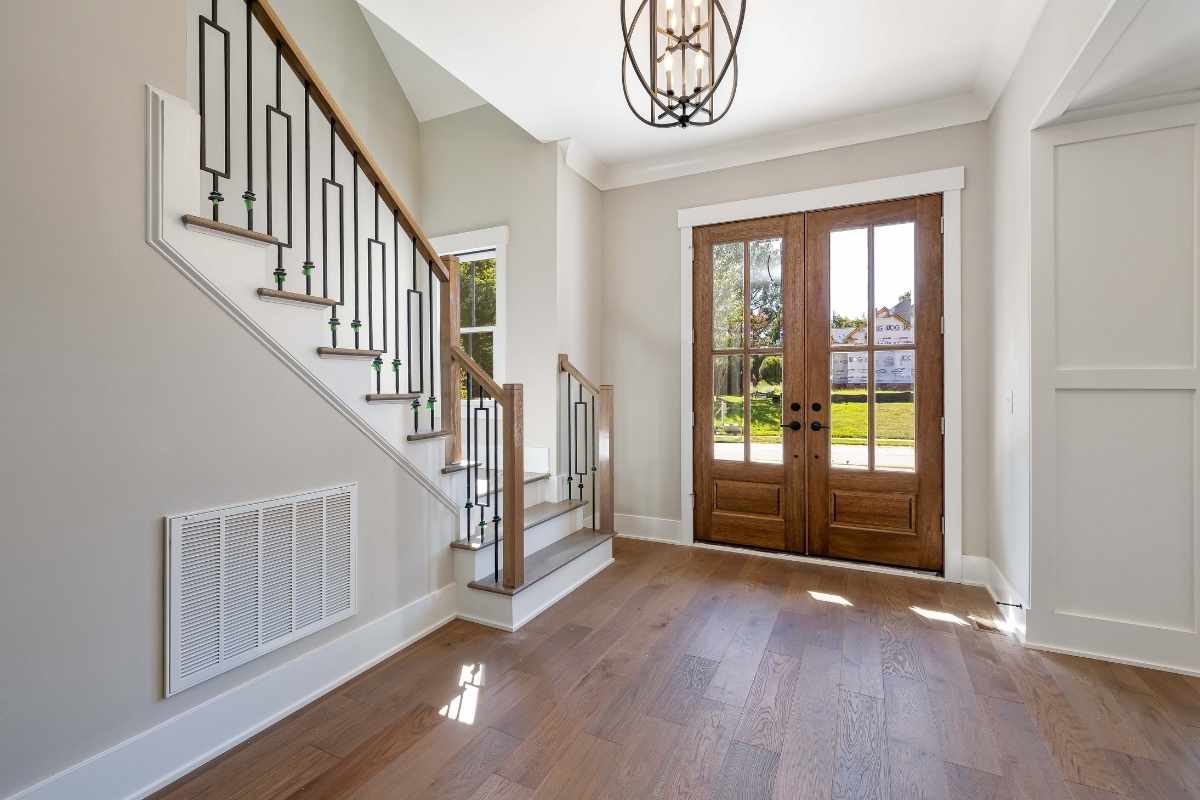 Clear glass entry doors allowing natural light into a contemporary home interior