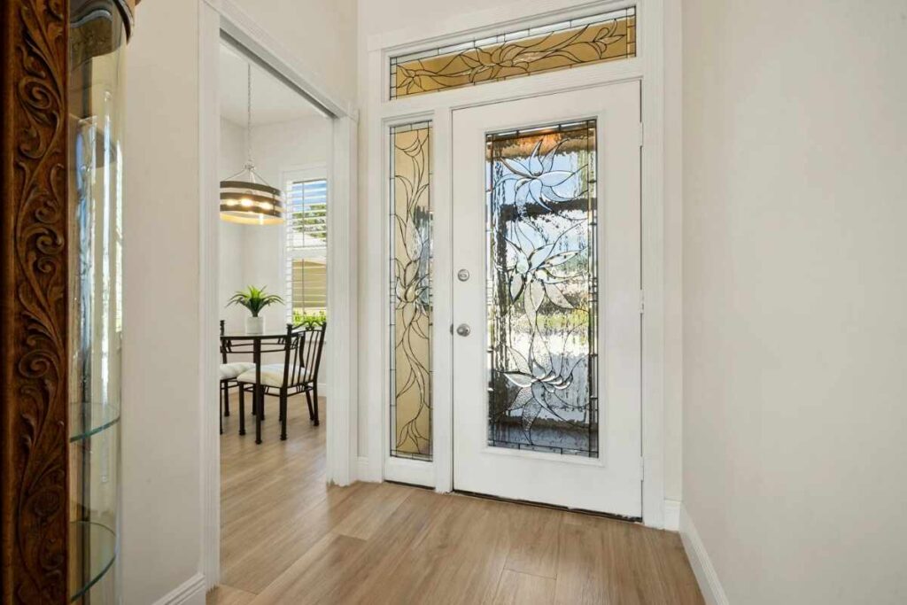 Stained glass front door with sidelight and transom windows