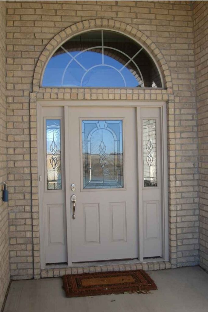 Front door and beveled glass transom and sidelight windows