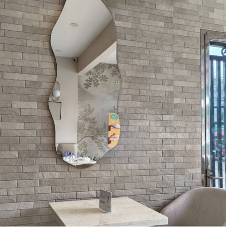 Interior with abstract mirror on brick wall