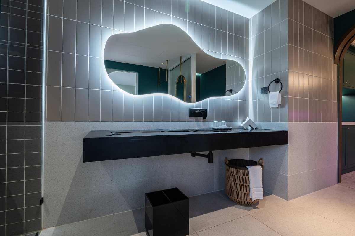 Modern bathroom interior with unique mirror and stylish decor