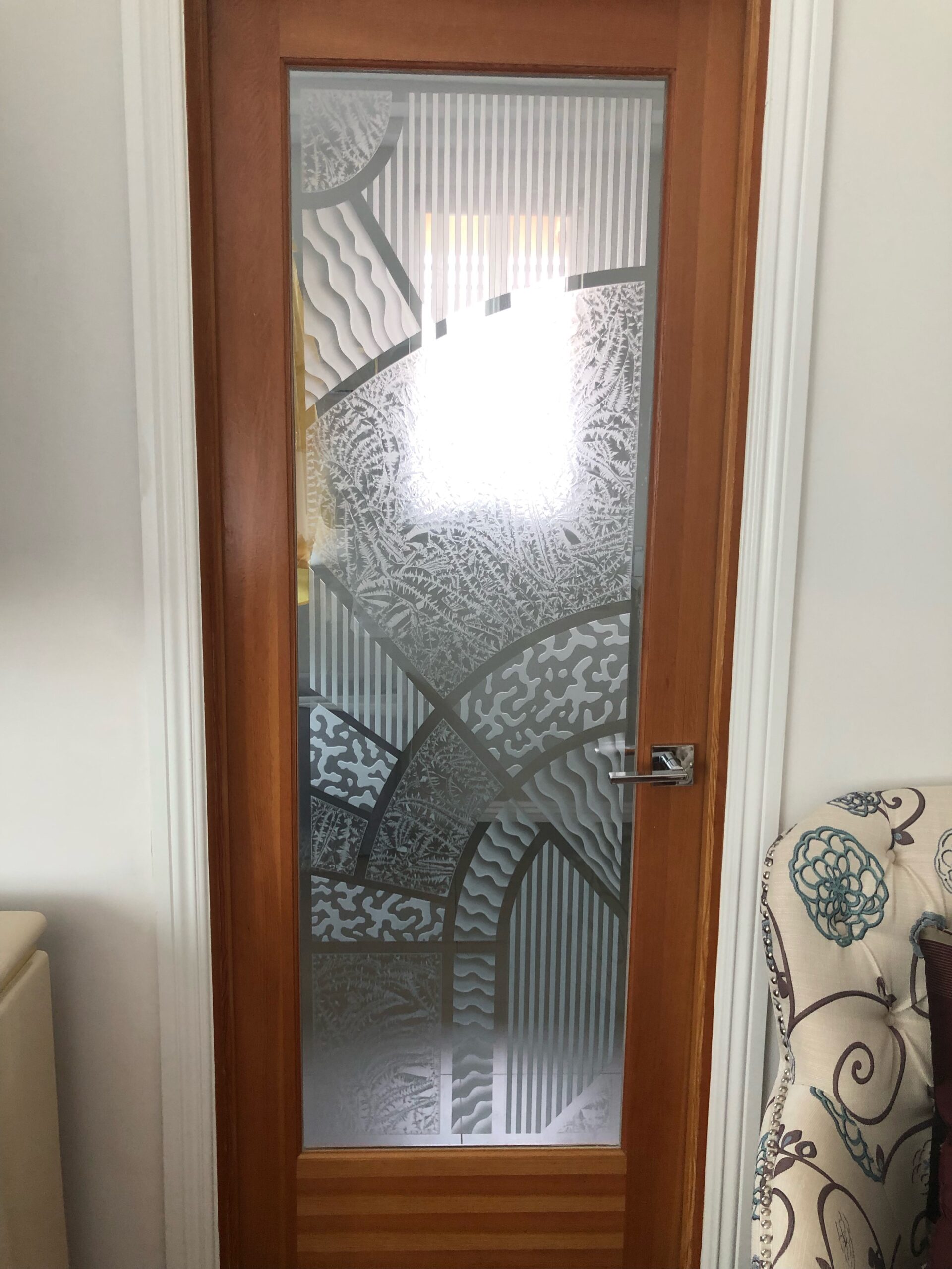 Interior wood door with custom frosted glass featuring the Matrix Arcs geometric etched and carved design