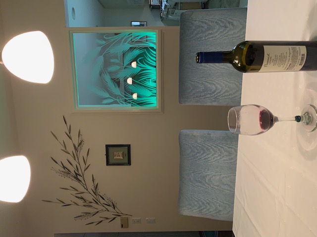 carved glass interior window panel with etched wheat design illuminated with green edge lighting for ambient effect